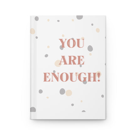 Notebook with 'YOU ARE ENOUGH!' text on a white background