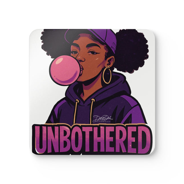 Cork coaster of a woman blowing a bubble gum bubble and the word 'UNBOtherED' on a white background
