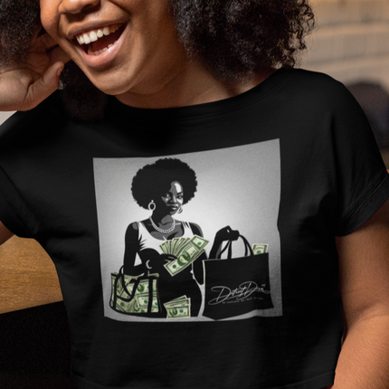 Person wearing a black t-shirt with a graphic design of a woman holding money and bags.