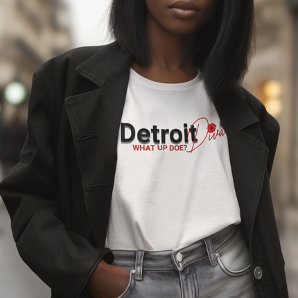 Person wearing a white t-shirt with 'Detroit Diva' text that says "What Up Doe?" standing outdoors.