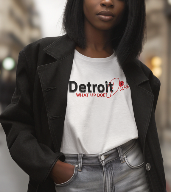 Person wearing a white t-shirt with 'Detroit Diva' text that says "What Up Doe?" standing outdoors.