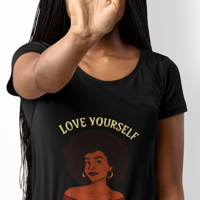 Person wearing a black t-shirt with 'Love Yourself First' text and graphic design.