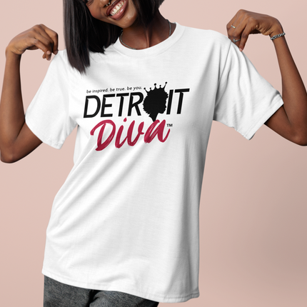 Woman wearing a white t-shirt with 'Detroit Diva' design on a pink background