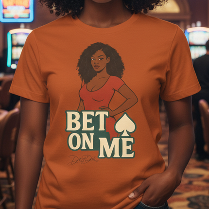 Woman wearing an orange t-shirt with a graphic and text in a casino setting