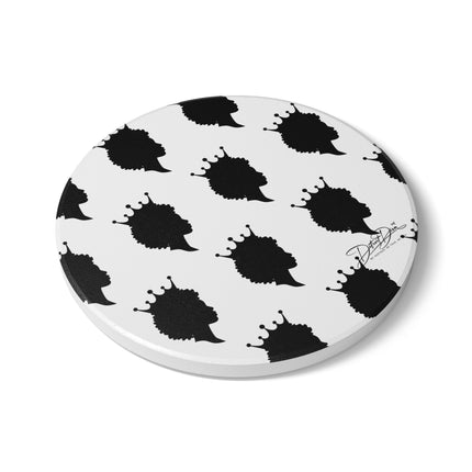 Round white coaster with black abstract designs on a white background
