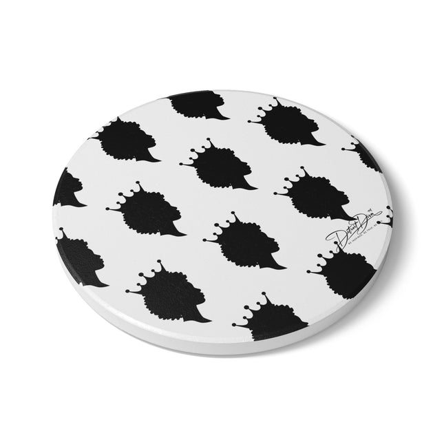 Round white coaster with black abstract designs on a white background