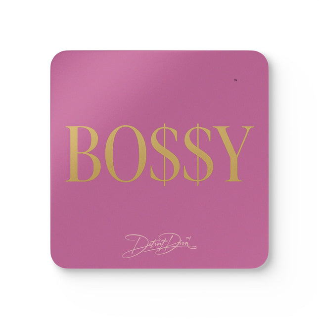 Pink mouse pad with 'BOSSY' in gold letters and a signature logo on a white background