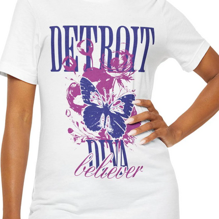 White t-shirt with purple butterfly graphic and 'Detroit Diva Believer' text on a white background